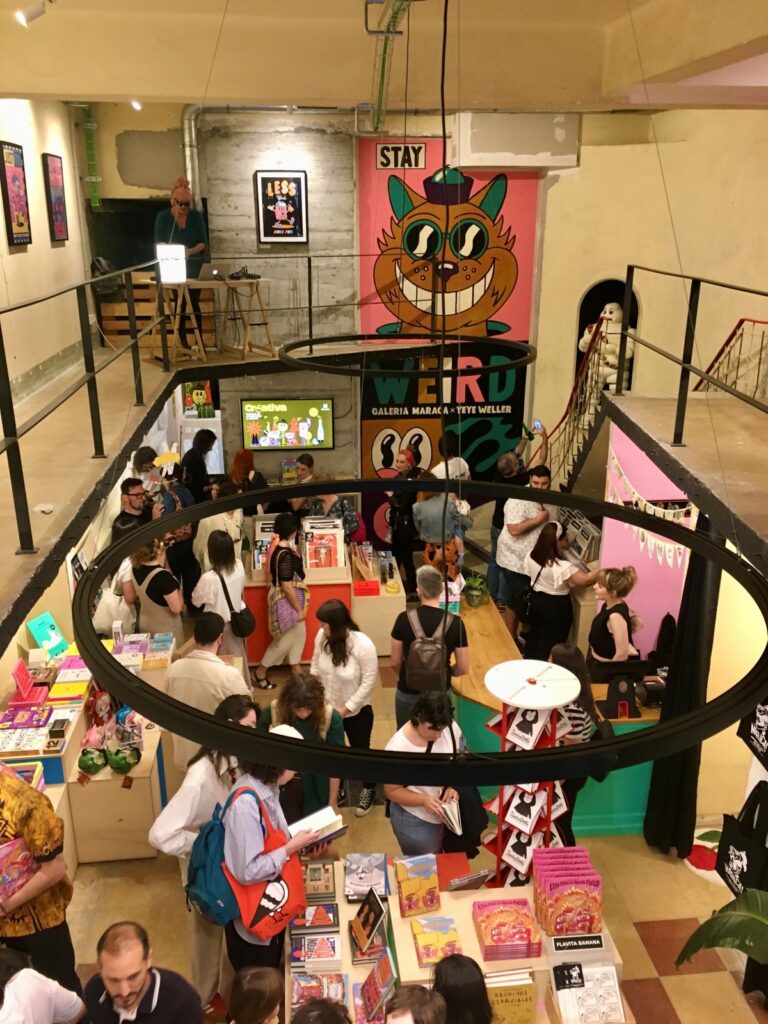 A crowd of people hanging out in at art galleries in Vigo, Spain.
